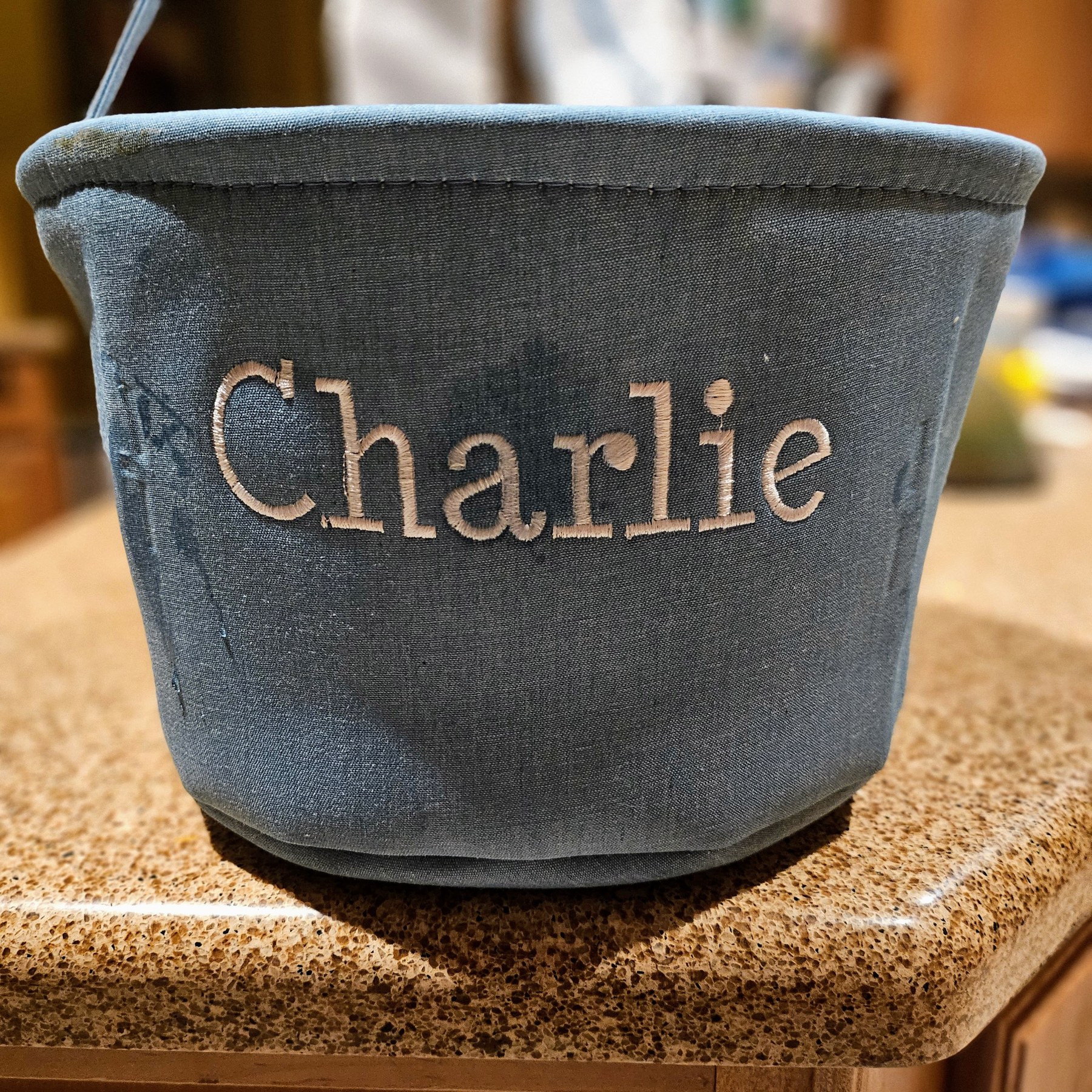 Blue bucket bag embroidered with the name Charlie