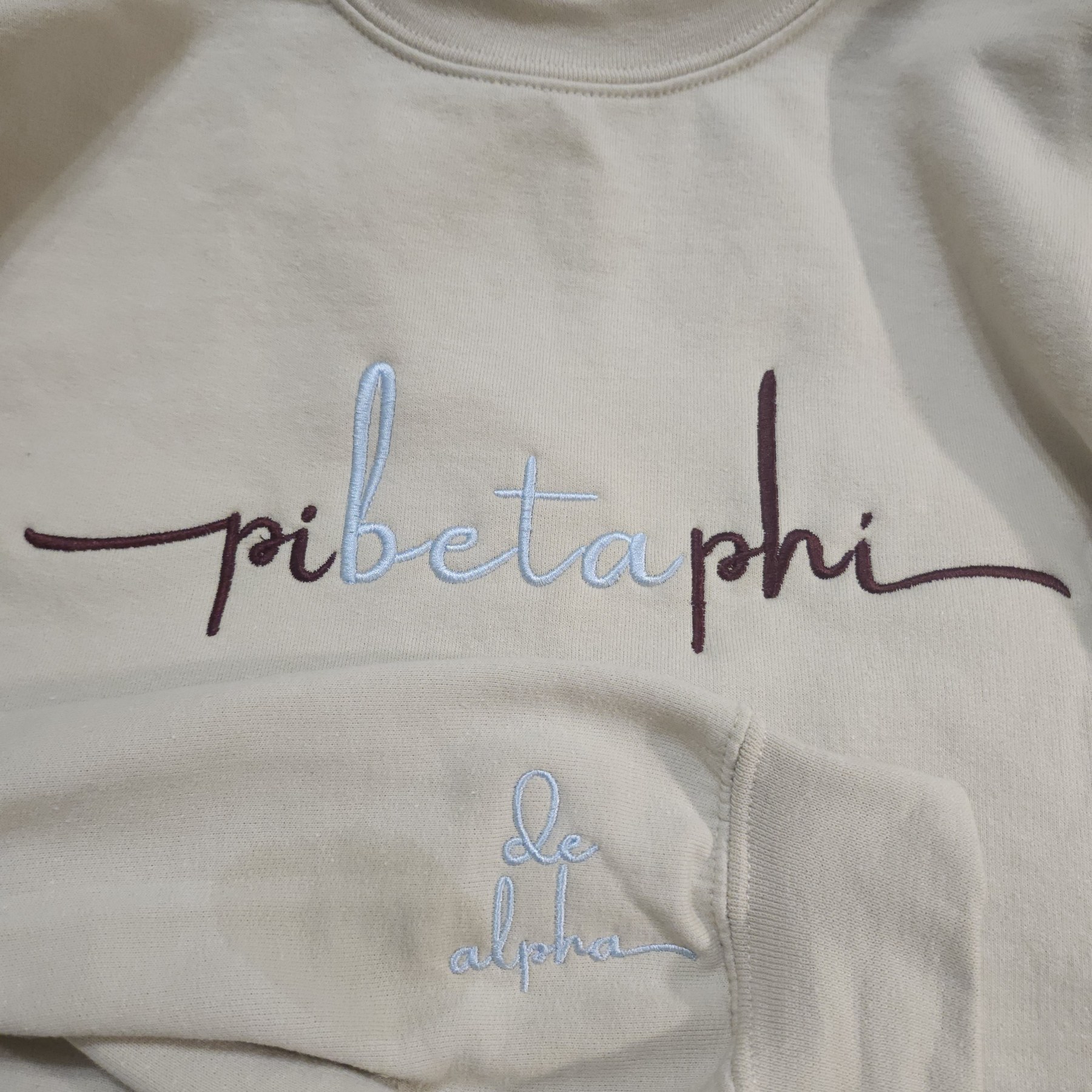Cream hoodie with Greek life embroidery